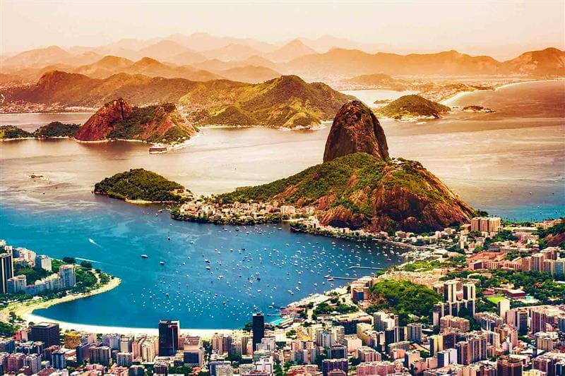 Brazil Visa Aerial view of Sugarloaf Mountain and Guanabara Bay in Rio de Janeiro, Brazil with surrounding cityscape and islands
